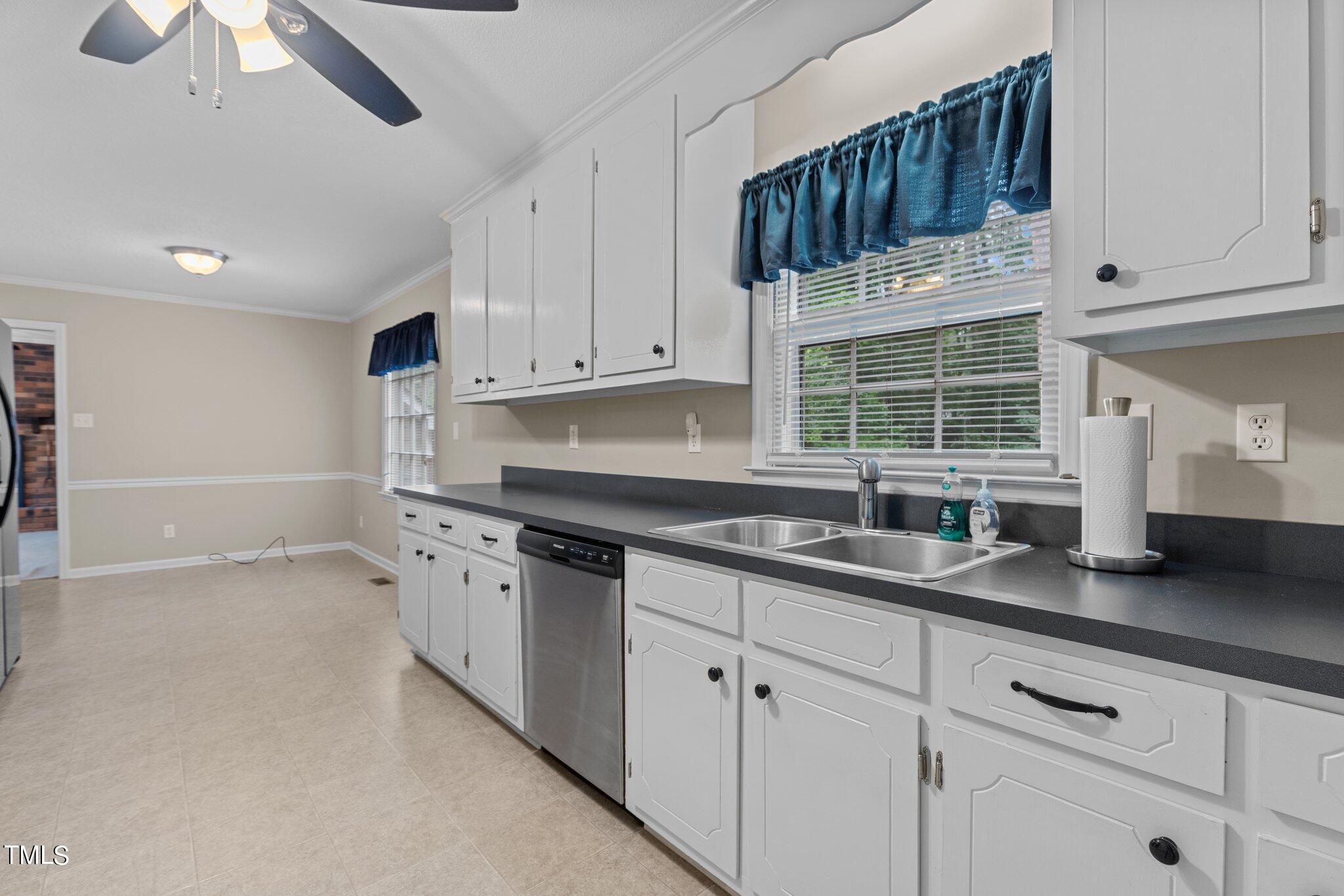 5125 Russell Road Durham, NC 27712 - Photo 14 of 59 a kitchen with stainless steel appliances granite countertop a sink a stove and a refrigerator