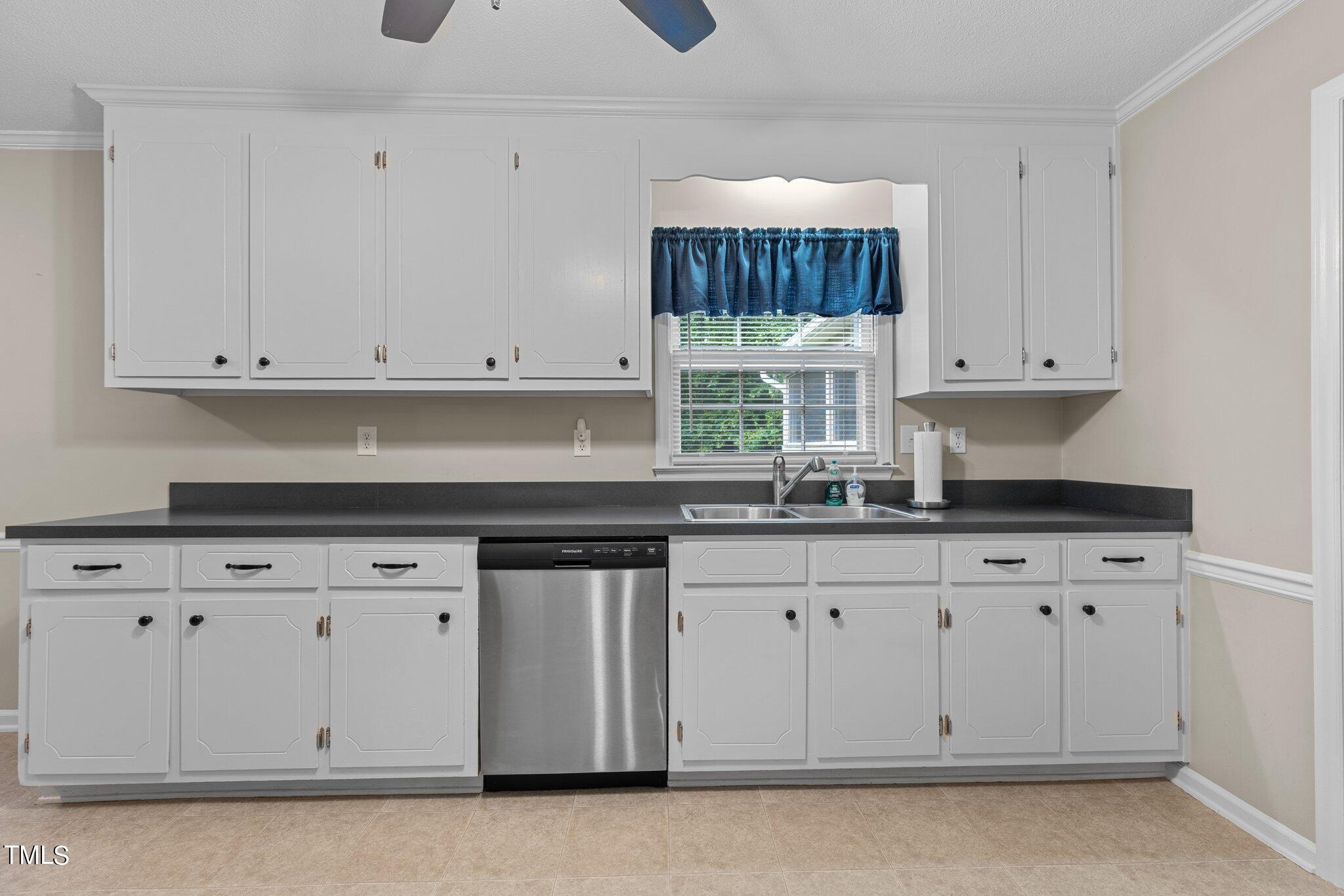 5125 Russell Road Durham, NC 27712 - Photo 15 of 59 a kitchen with granite countertop white cabinets and a stove