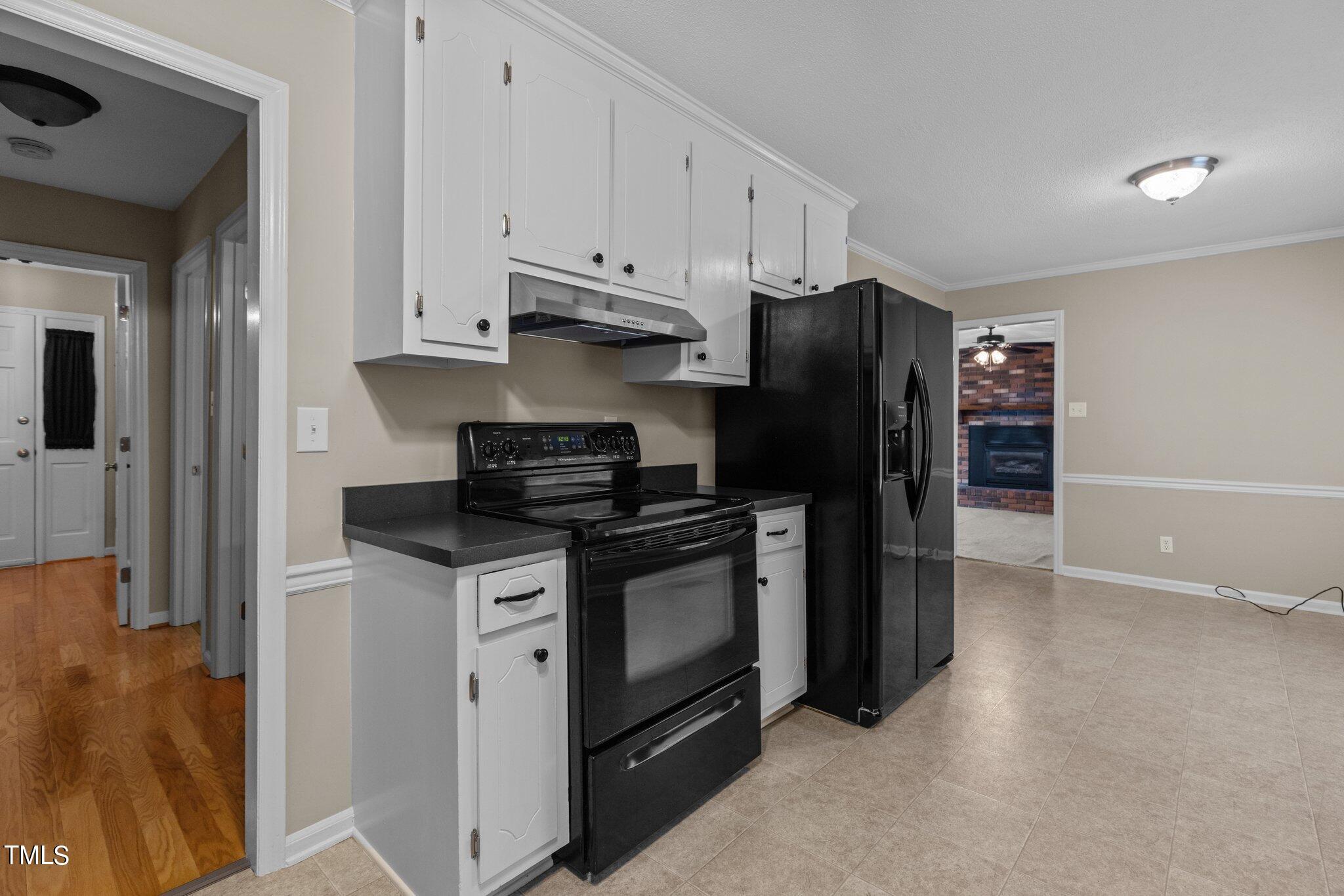 5125 Russell Road Durham, NC 27712 - Photo 16 of 59 a kitchen with stainless steel appliances granite countertop a refrigerator and a stove