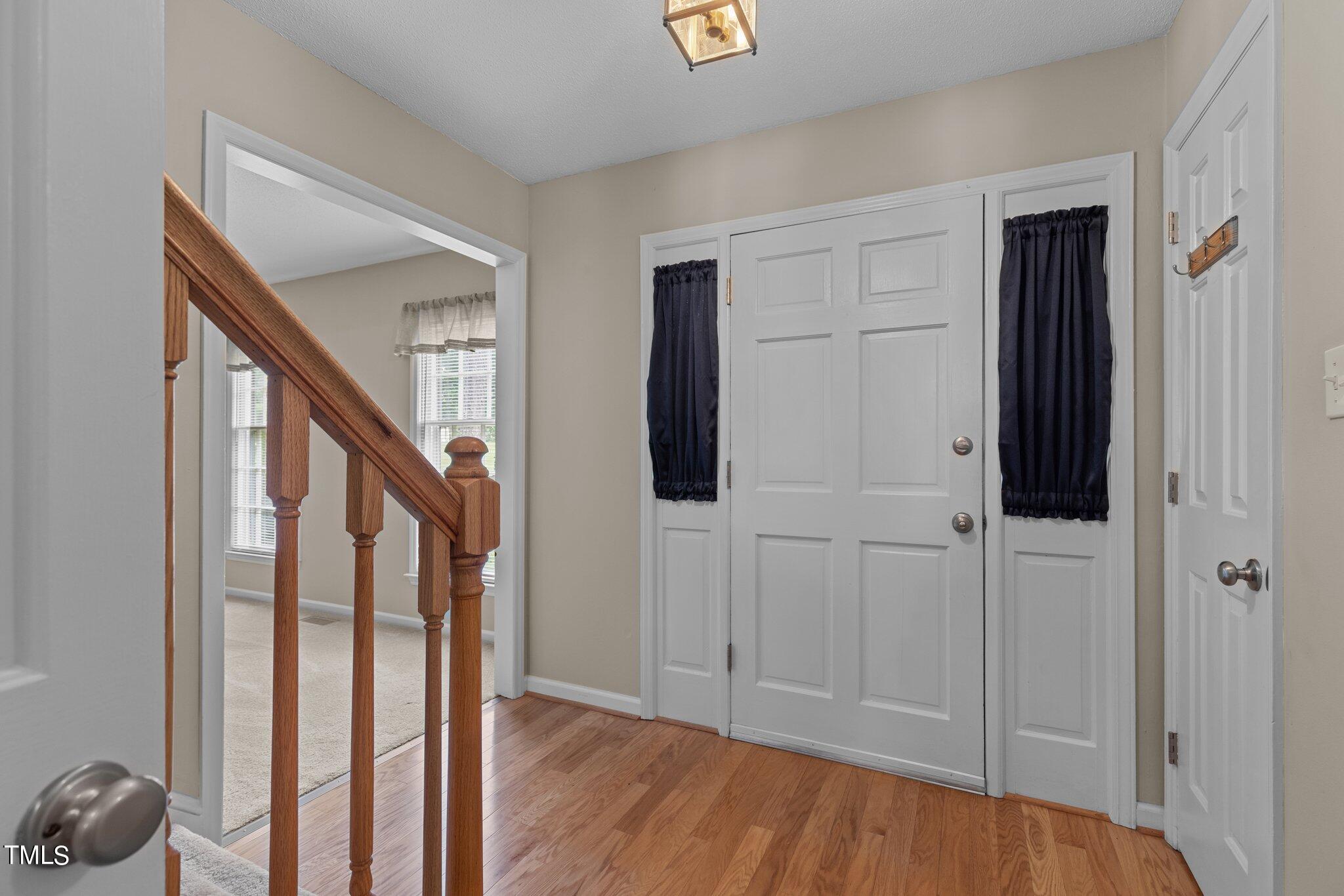 5125 Russell Road Durham, NC 27712 - Photo 3 of 59 a view of entryway with wooden floor