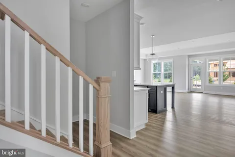 a view of an entryway with wooden floor and windows