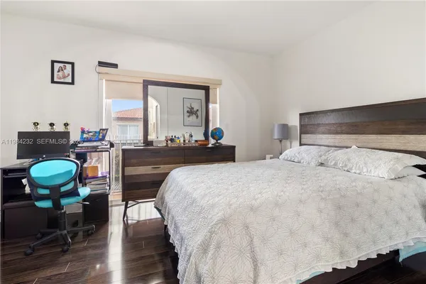 a bedroom with a bed and chair