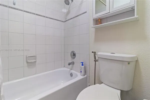 a white bath tub sitting next to a white toilet