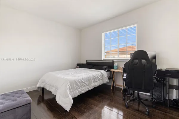 a bedroom with a bed chair and a window