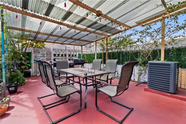 a view of a chairs and table in patio