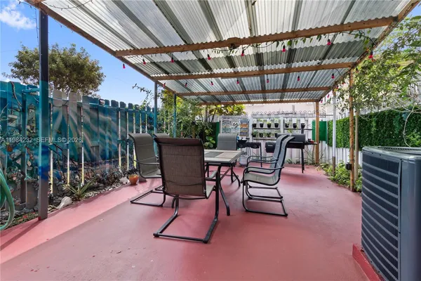 a view of a chairs and table in backyard