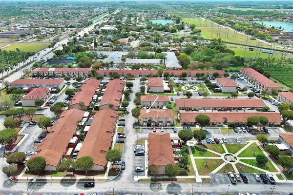 an aerial view of residential houses with outdoor space and ocean view