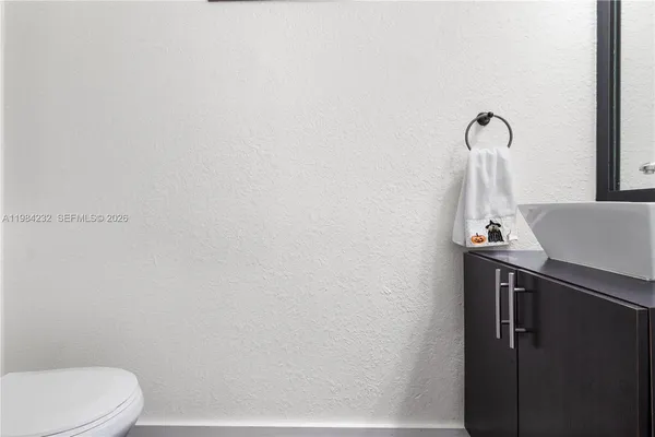a bathroom with a sink a toilet and mirror