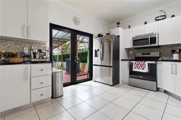 a kitchen with stainless steel appliances a refrigerator sink and cabinets