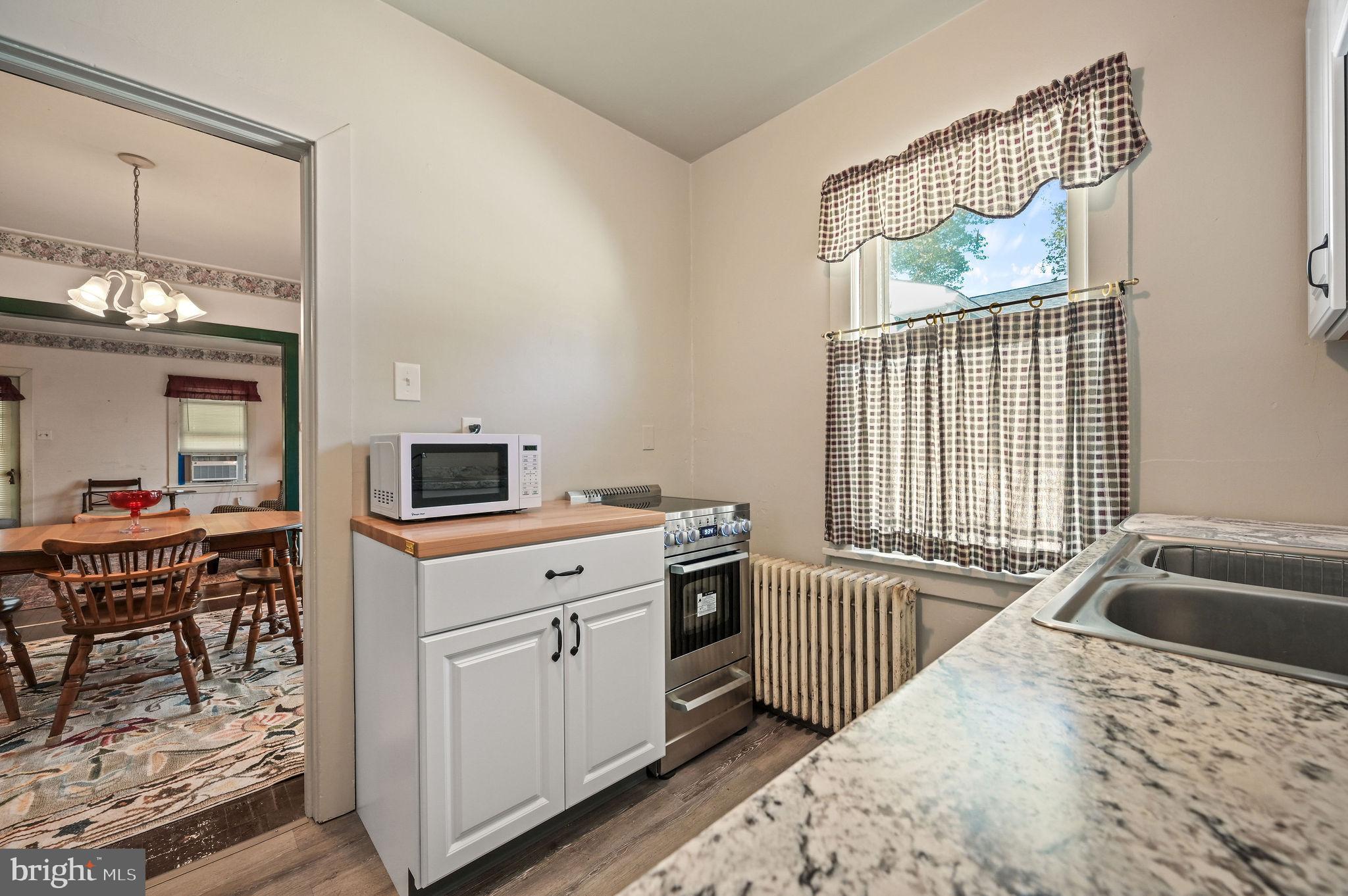 135 Pine Street Dover, DE 19901 - Photo 11 of 27 a kitchen that has a sink and a stove in it