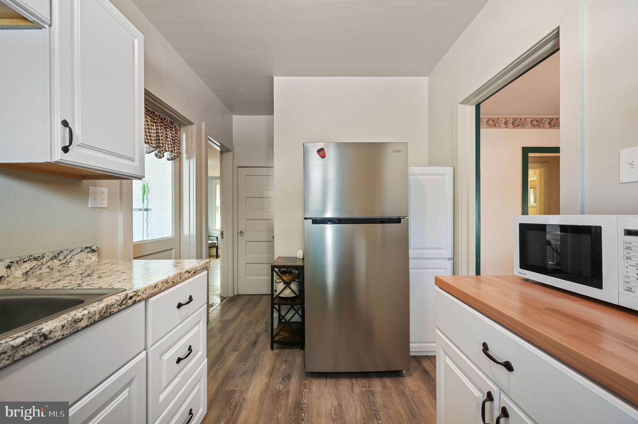 135 Pine Street Dover, DE 19901 - Photo 12 of 27 a kitchen with a refrigerator sink and cabinets