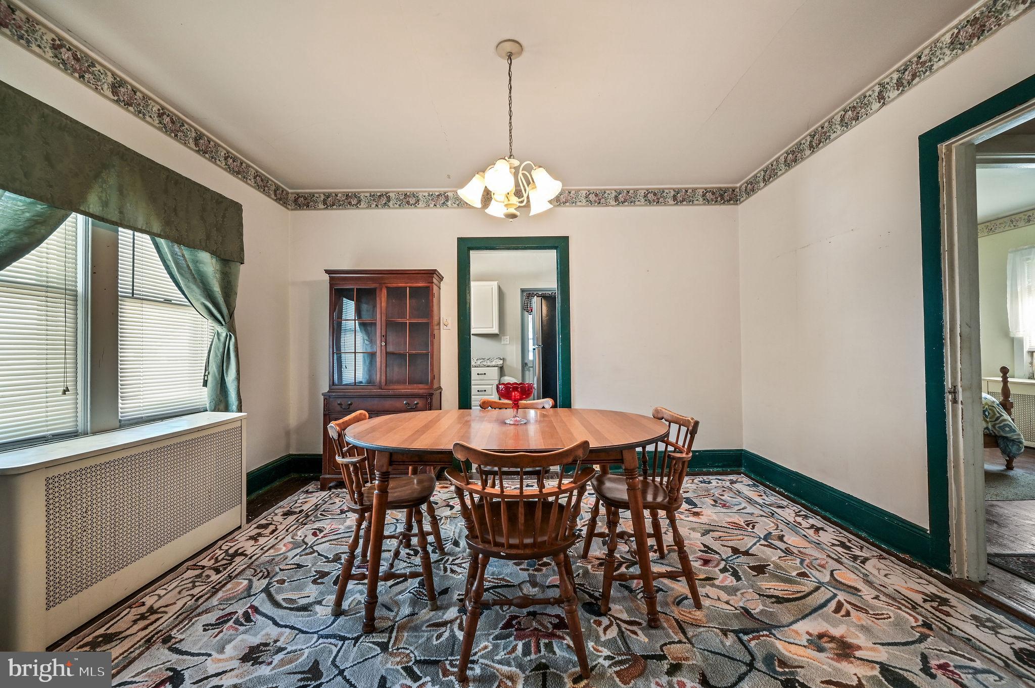 135 Pine Street Dover, DE 19901 - Photo 7 of 27 a dining room with chandelier and wooden floor