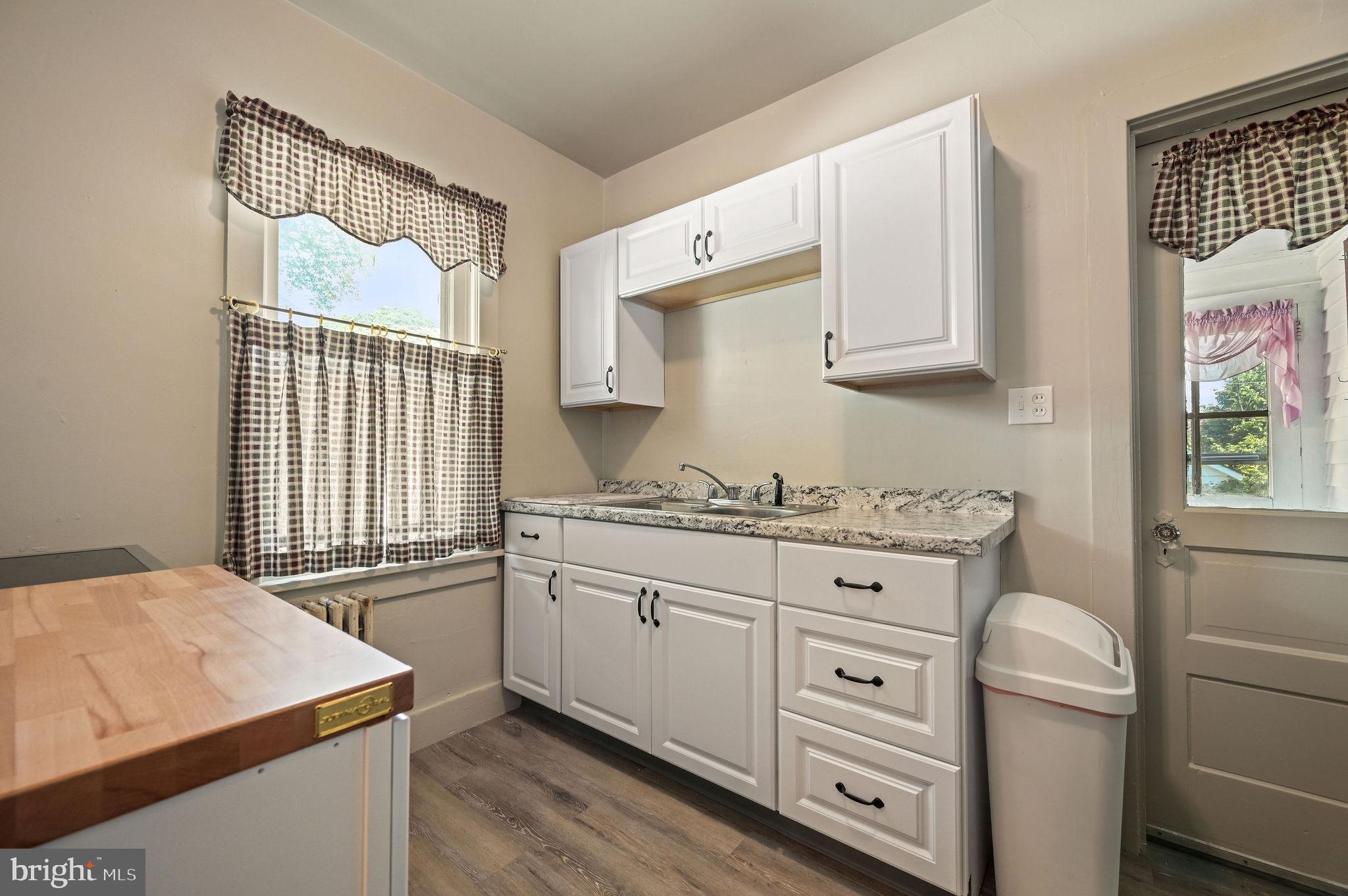 135 Pine Street Dover, DE 19901 - Photo 10 of 27 a kitchen with granite countertop white cabinets and white appliances