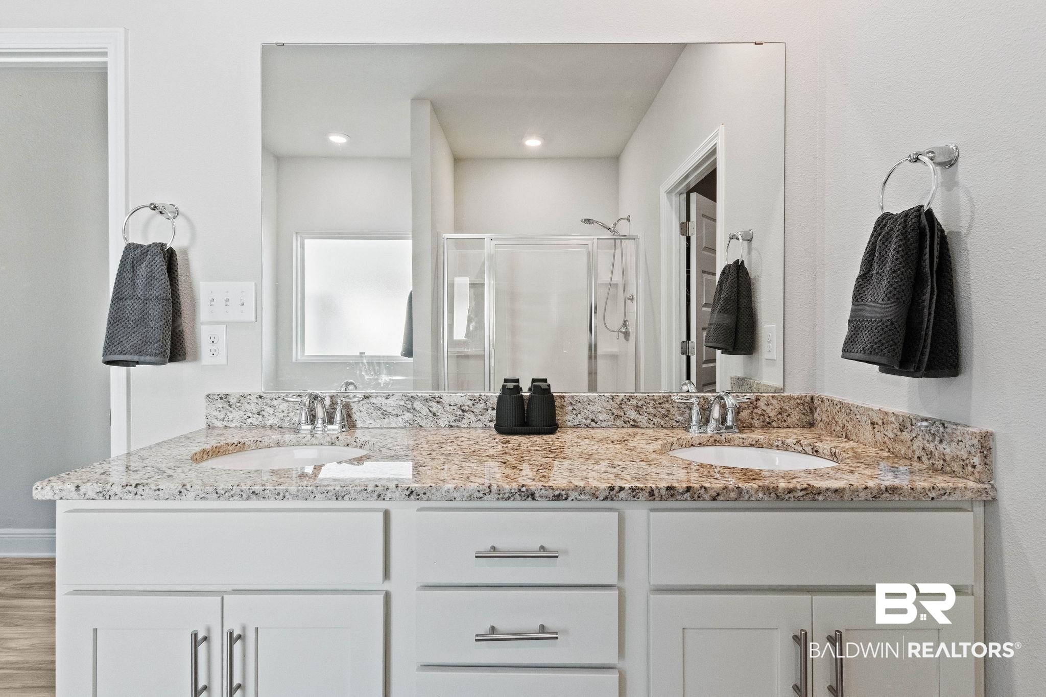 24939 Spectacular Bid Loop Daphne, AL 36526 - Photo 18 of 38 Full bathroom featuring a shower stall, double vanity, and wood finished floors