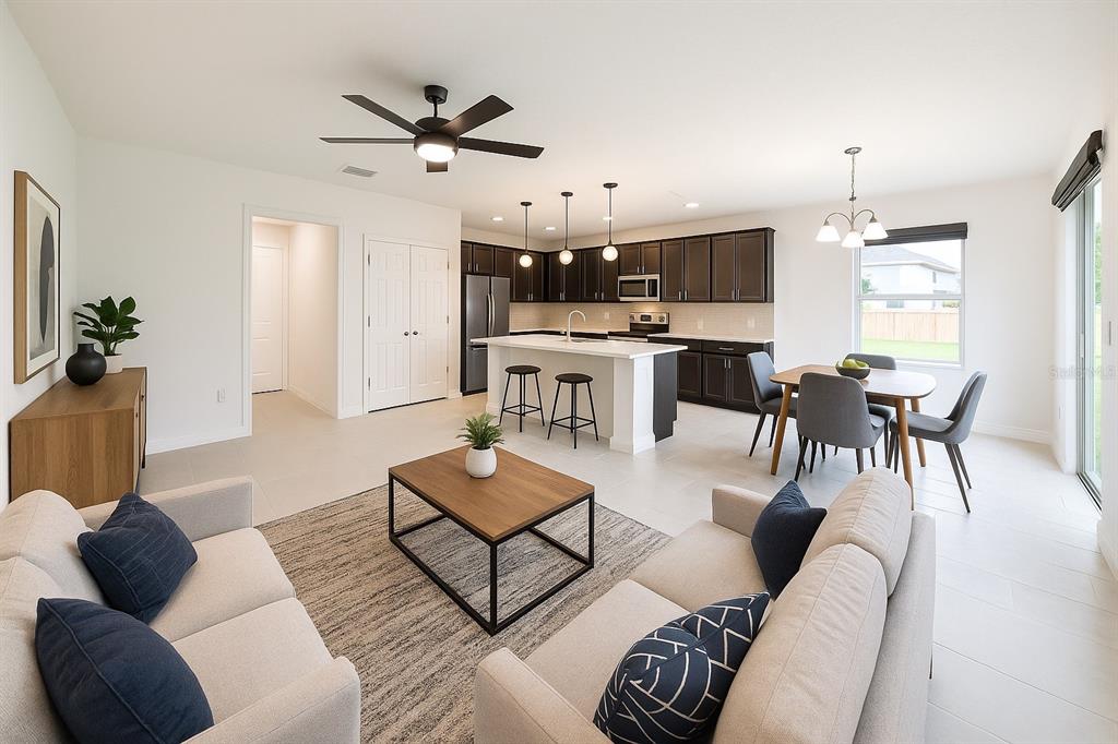 1193 Cavender Creek Road Minneola, FL 34715 - Photo 2 of 22 a living room with furniture kitchen view and a chandelier