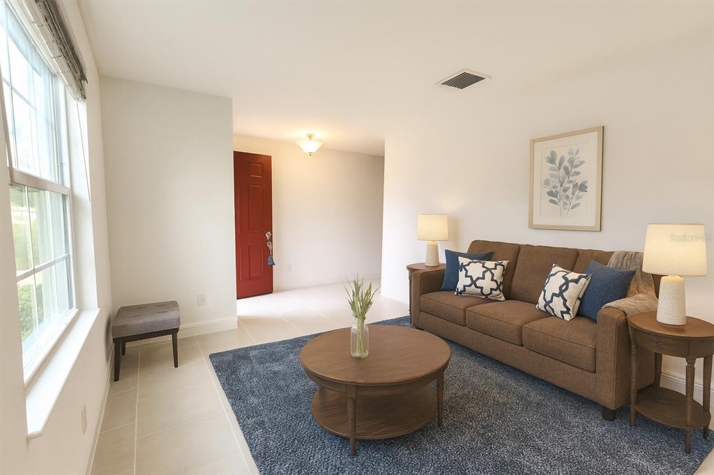 1193 Cavender Creek Road Minneola, FL 34715 - Photo 21 of 22 a living room with furniture and a large window