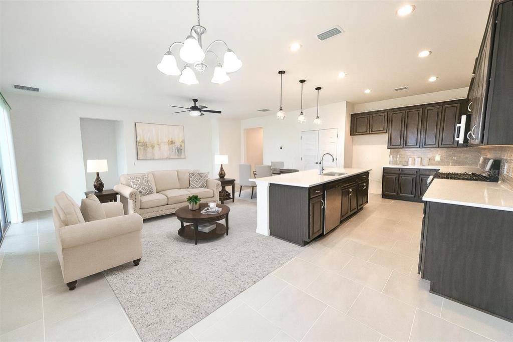 1193 Cavender Creek Road Minneola, FL 34715 - Photo 6 of 22 a living room with furniture and a chandelier