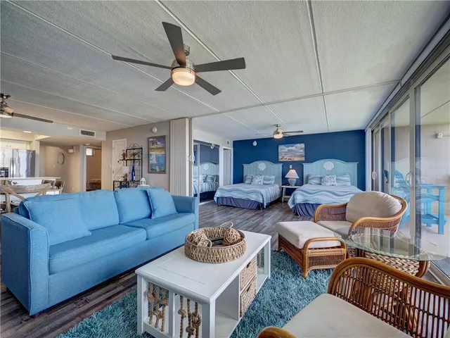 a living room with furniture a rug and a chandelier
