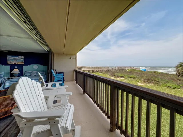 a view of a chairs and table in patio
