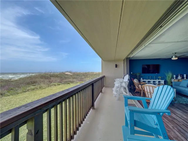 a view of a chairs and table in the balcony