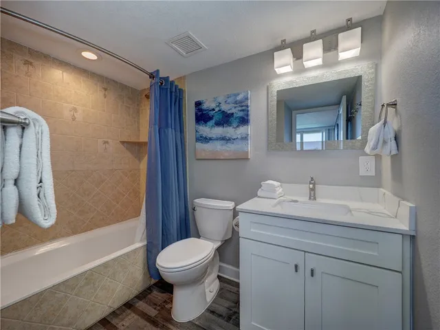 a bedroom with a bed and a ceiling fan