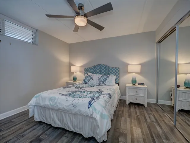 a spacious bedroom with a bed and a chandelier
