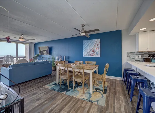 a dining room with furniture a rug and wooden floor