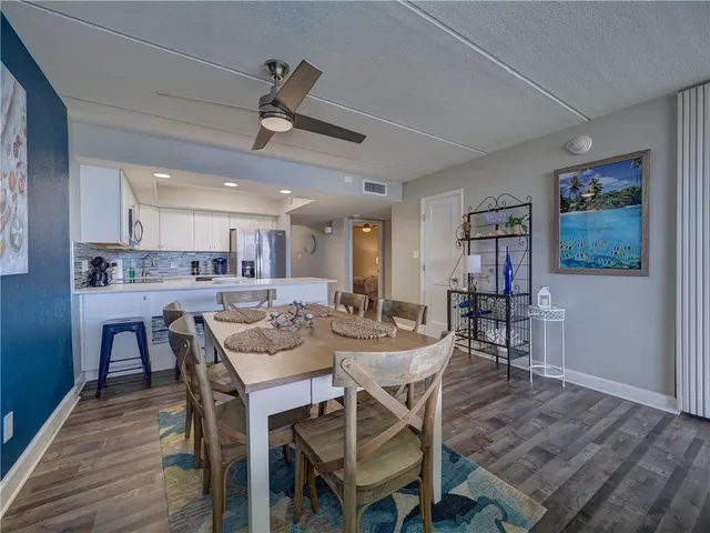 a view of a dining room with furniture and wooden floor