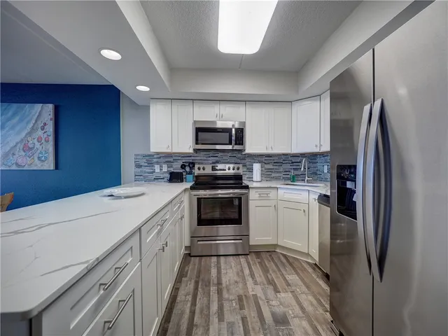 a kitchen with a refrigerator stove and sink
