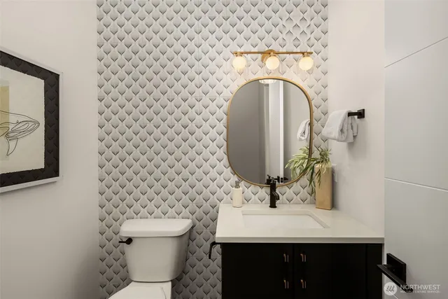 a bathroom with a sink toilet and mirror