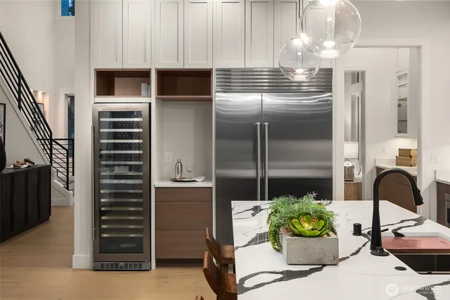 a kitchen with a refrigerator and cabinets