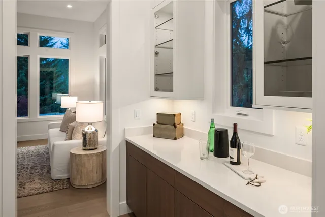 a kitchen with a sink and dishwasher a refrigerator with white cabinets