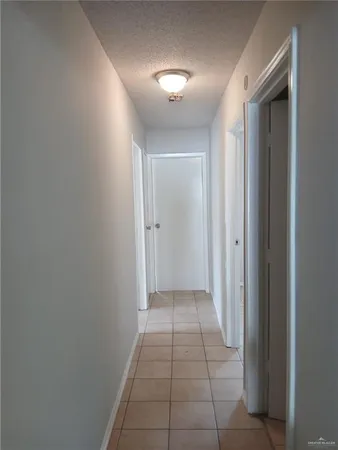 a view of hallway with a rug and a window