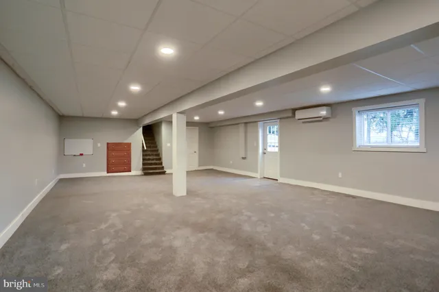 an empty room with a hallway and stairs