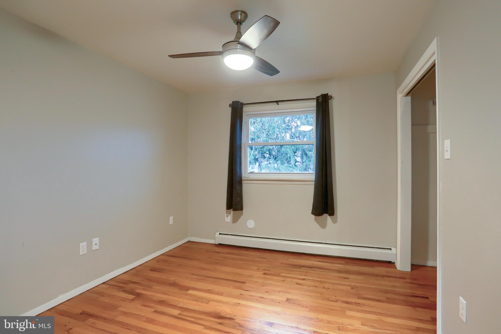 509 Shaffer Road Millersburg, PA 17061 - Photo 17 of 28 a view of an empty room with wooden floor and a ceiling fan