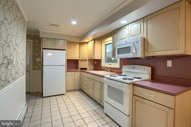 a kitchen with a sink cabinets and window