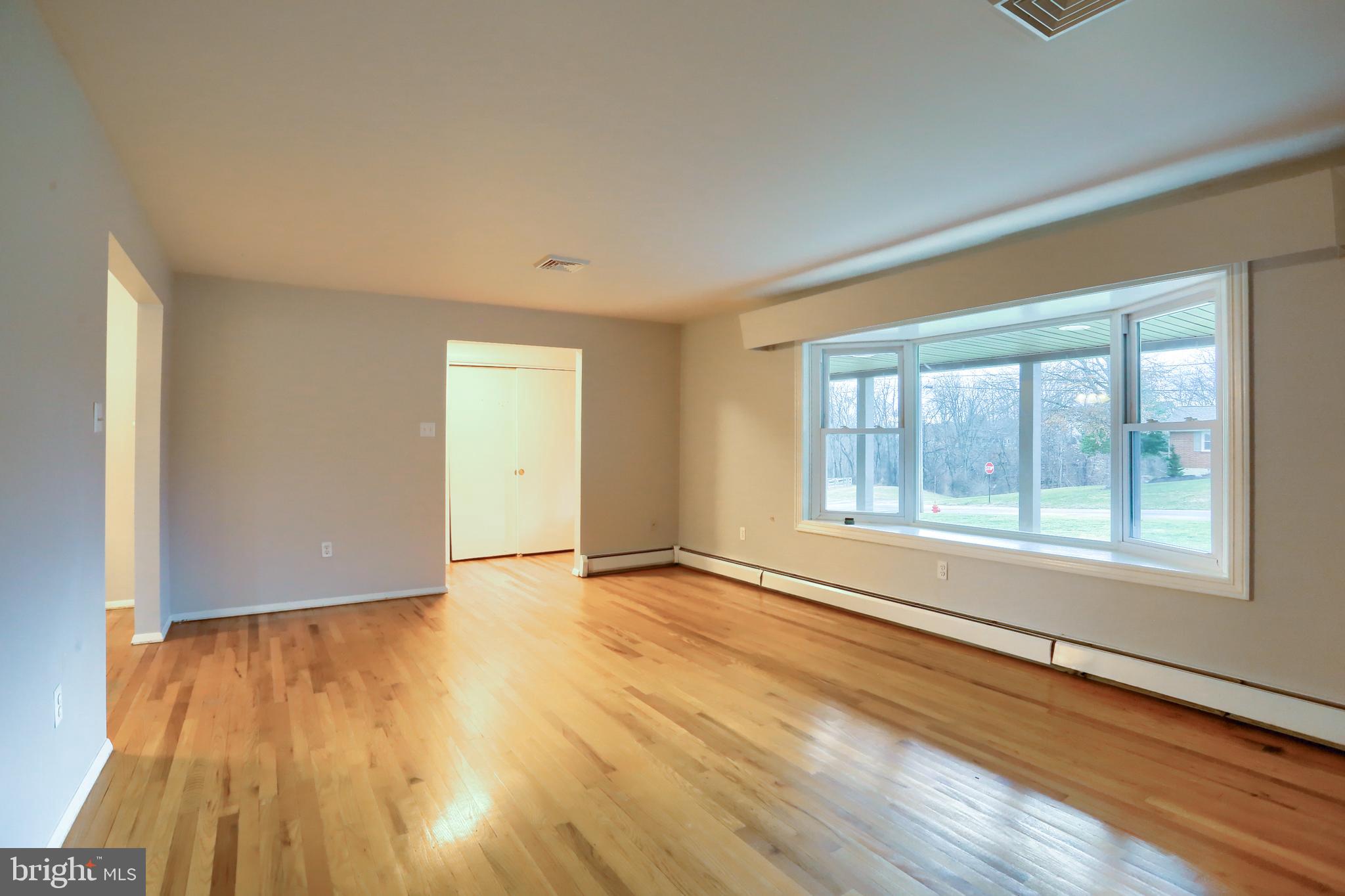 509 Shaffer Road Millersburg, PA 17061 - Photo 3 of 28 a view of an empty room with wooden floor and a window