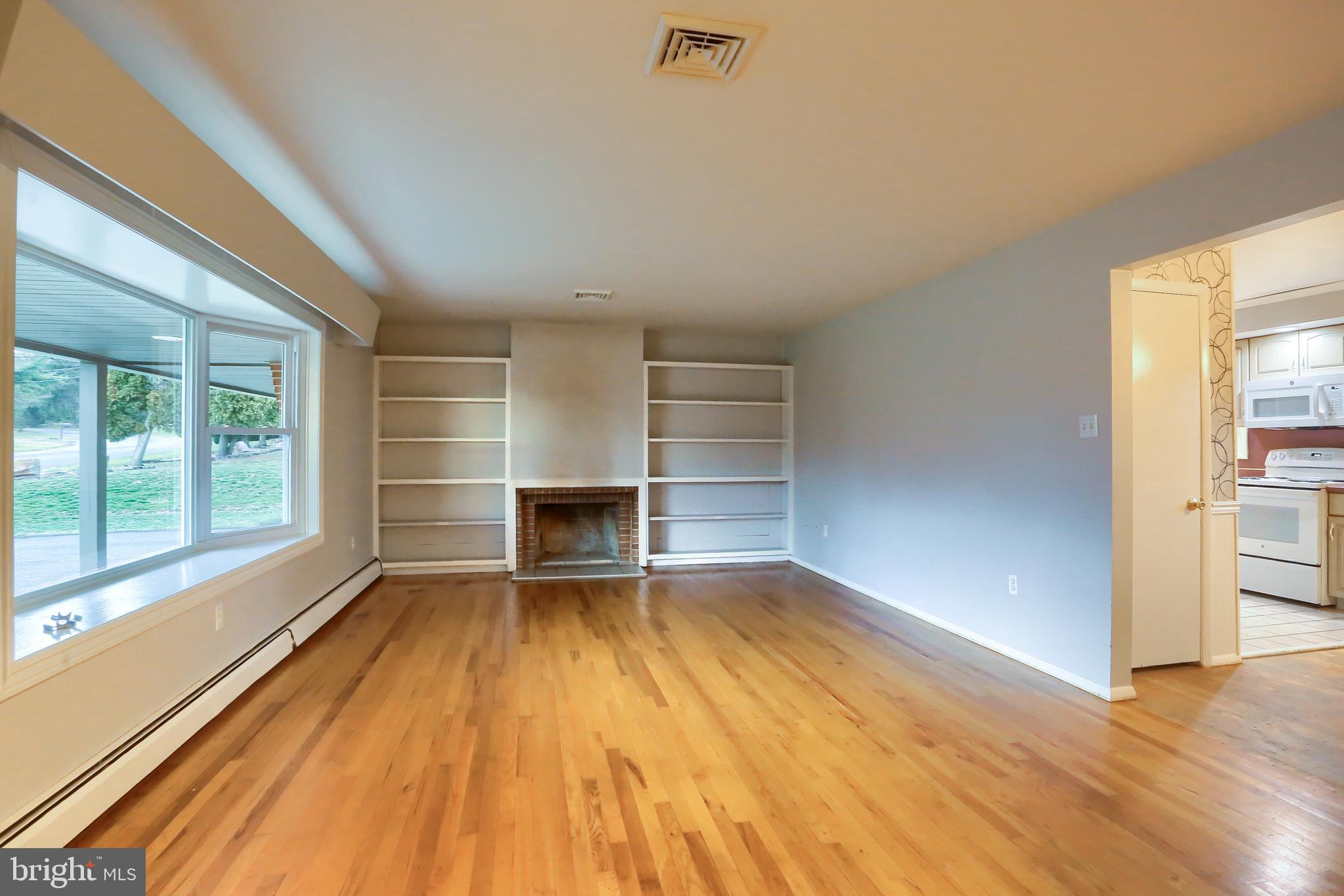 509 Shaffer Road Millersburg, PA 17061 - Photo 4 of 28 a view of an empty room with a window and wooden floor
