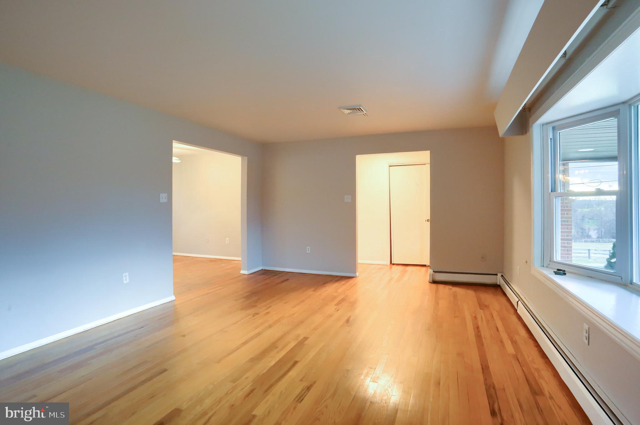 509 Shaffer Road Millersburg, PA 17061 - Photo 5 of 28 a view of an empty room with wooden floor and a window