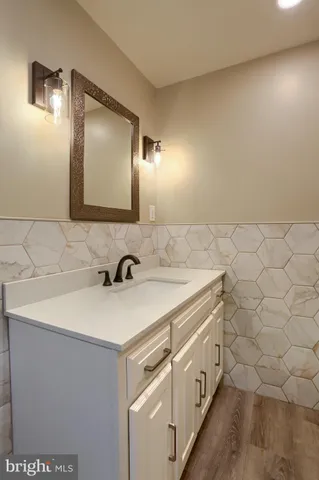 a bathroom with a sink a vanity and a mirror