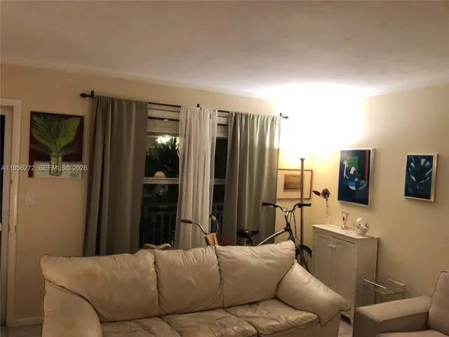 a living room with furniture and a painting