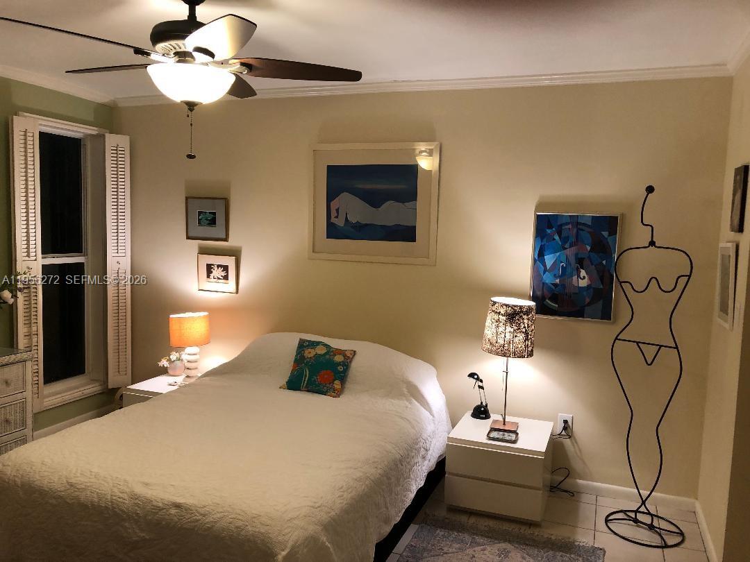 255 Sunrise Drive, Unit 305 Key Biscayne, FL 33149 - Photo 19 of 50 a bedroom with a bed and a chandelier