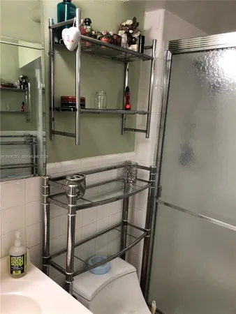 a bathroom with a glass shower door