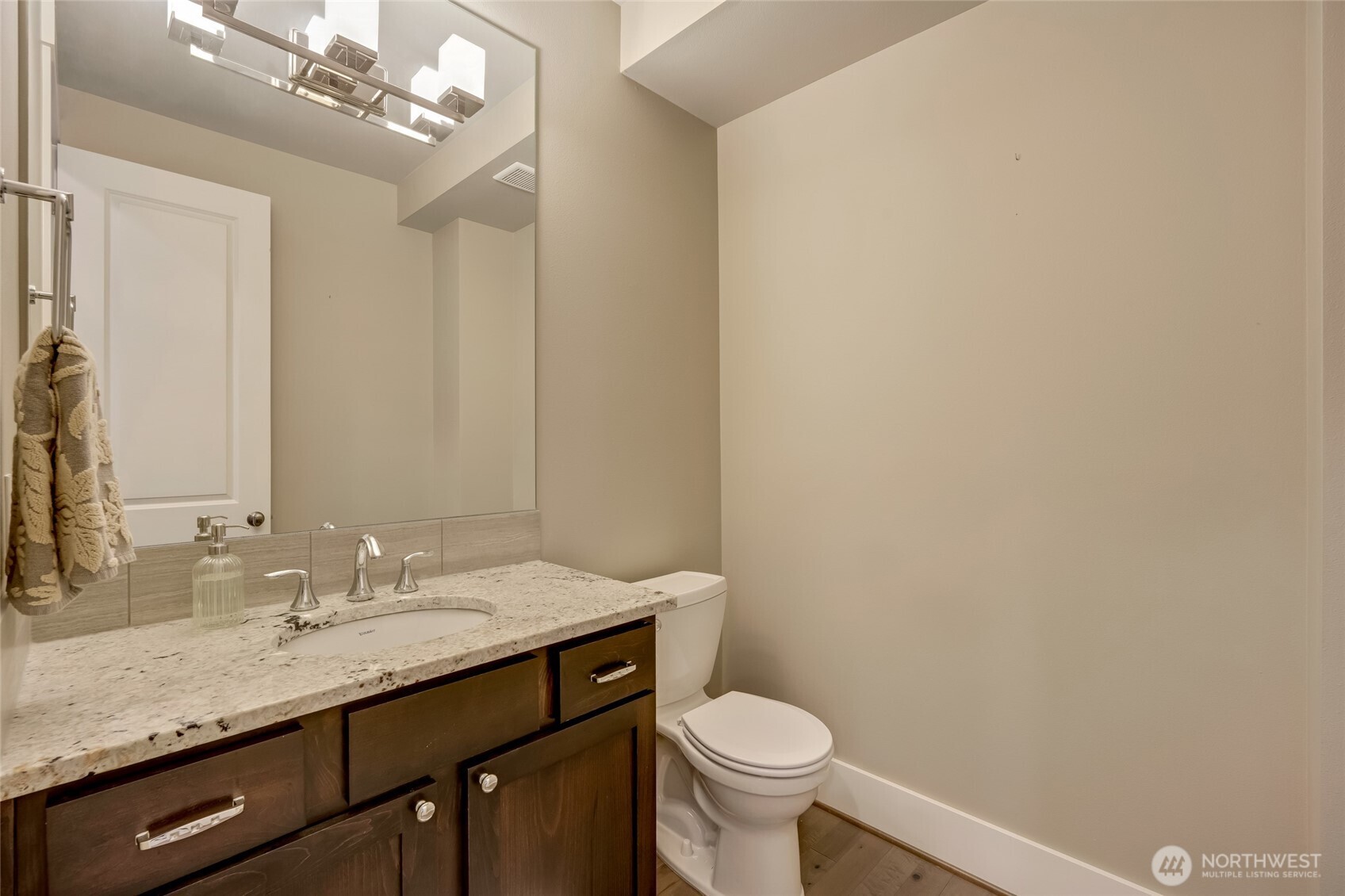 619 Graham Avenue Northeast Renton, WA 98059 - Photo 21 of 40 a bathroom with a granite countertop sink a toilet and a mirror