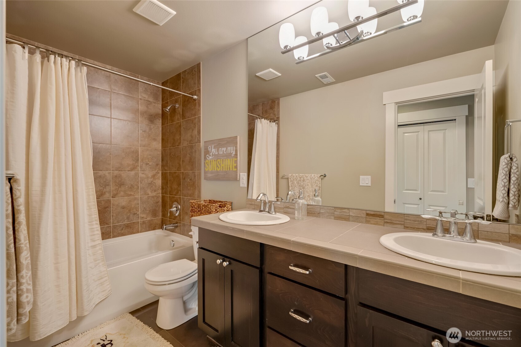 619 Graham Avenue Northeast Renton, WA 98059 - Photo 35 of 40 a bathroom with a granite countertop sink a toilet a mirror and shower