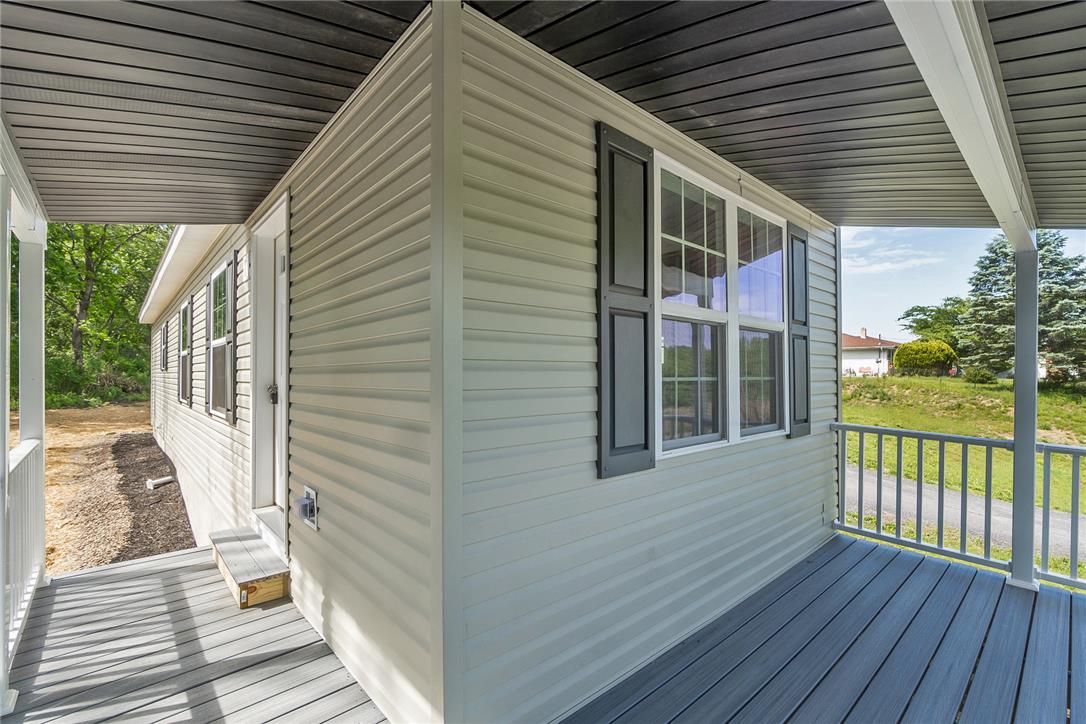 624 Main Road Lehighton, PA 18235 - Photo 11 of 42 A welcoming front porch with composite decking offers a serene spot for relaxation.