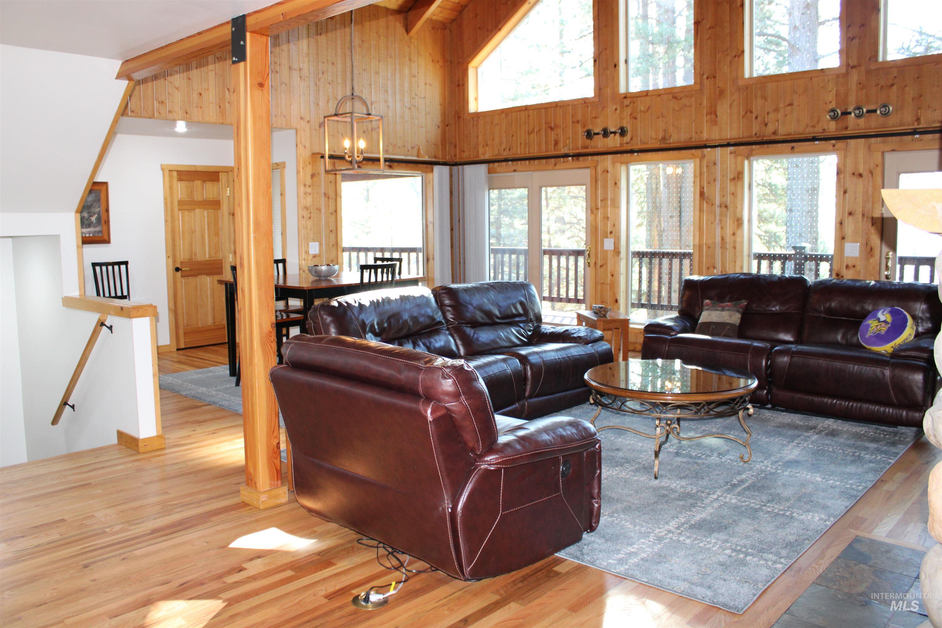 31 Rainbow Ridge Road Garden Valley, ID 83622 - Photo 11 of 33 Great room featuring wood walls, high vaulted ceiling, wood flooring, and a ceiling fan