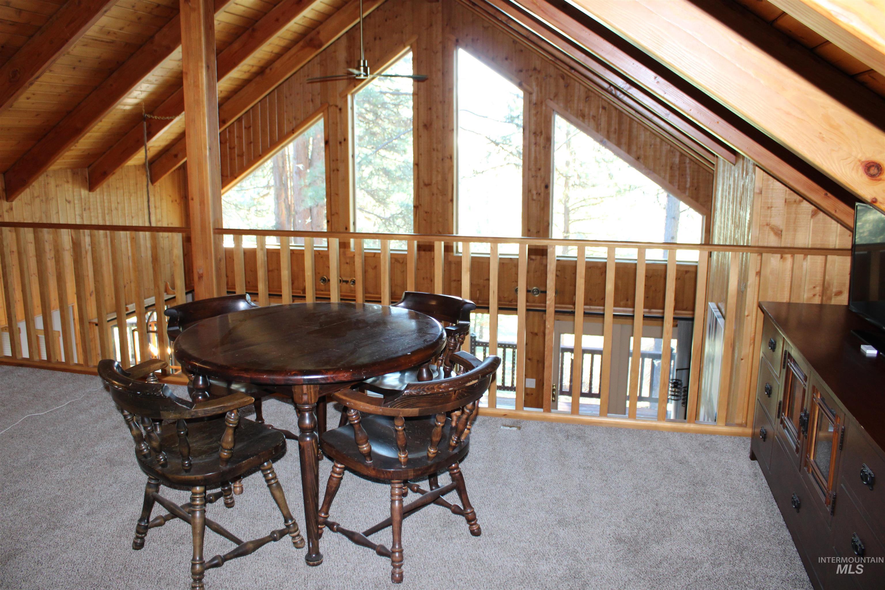 31 Rainbow Ridge Road Garden Valley, ID 83622 - Photo 16 of 33 Loft area featuring carpet flooring, a wood ceiling with exposed beams, and wooden walls