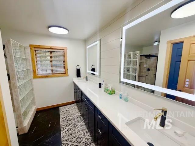 31 Rainbow Ridge Road Garden Valley, ID 83622 - Photo 19 of 33 Primary bath with double vanities, backlit mirrors, stand up shower, linen closet and separate toilet room
