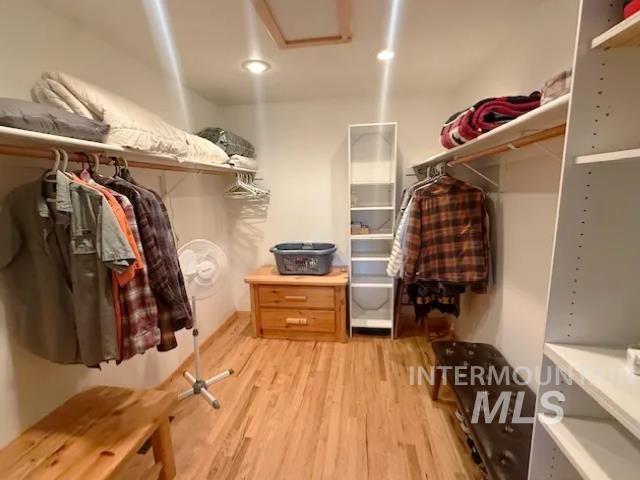 31 Rainbow Ridge Road Garden Valley, ID 83622 - Photo 20 of 33 Primary walk in closet with light wood flooring and attic access